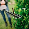 A person is using a hedge trimmer to cut branches from a bush. The image highlights the cutting capacity of the hedge trimmer. Anteprima dell’immagine prodotto