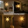 Collage of four images showing a paper star lantern in different home settings: living room with fireplace and Christmas tree, kitchen window, hallway, and bedroom. Podgląd zdjęcia produktu