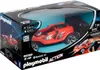 The image shows the retail packaging of a red Playmobil RC rocket racer with a remote control. The packaging is mostly black with blue accents and features images of the toy car and its features. Podgląd zdjęcia produktu