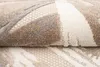 A close-up, folded view of a rug with a modern abstract pattern. Náhled obrázku produktu