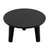 A black round plant stand with three legs on a white background. Voir les images du produit