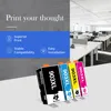 Four ink cartridges are displayed in the foreground, with a modern office space in the background. Produktbild-Vorschau