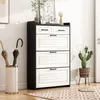 A shoe cabinet with drawers and flip-out compartments, decorated with a plant and umbrellas in a stand. Anteprima dell’immagine prodotto