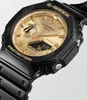 A close-up, angled shot of a black and gold Casio G-Shock watch against a white background. Produktbild-Vorschau