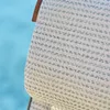 A close-up of woven fabric with a blue background. Produktbild-Vorschau