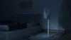 A bedroom at night with a standing fan. Anteprima dell’immagine prodotto