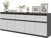 A modern sideboard with a dark top and white doors, decorated with various objects. Voir les images du produit
