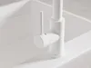 A close-up shot of a modern white kitchen faucet. Produktbild-Vorschau