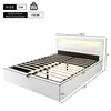 A white upholstered bed frame with a slatted base and LED lighting in the headboard, shown with dimensions indicated. Náhled obrázku produktu