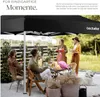 People enjoying a garden party under a black canopy. Produktbild-Vorschau