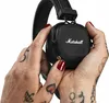 Hands holding black Marshall headphones. Náhľad obrázku produktu
