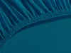 A close-up view of a teal-colored fitted sheet, showing the elasticized edge and gathered fabric. Produktbild-Vorschau