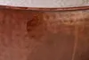 A close-up view of the textured surface of a copper table. Produktbild-Vorschau
