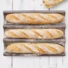 Three baguettes are shown in a baking tray. Anteprima dell’immagine prodotto