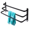 A black metal towel rack with three bars, holding two blue towels. Anteprima dell’immagine prodotto