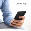 A person's hand holding a black smartphone with a case on it. Produktbild-Vorschau