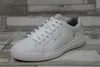 A white leather sneaker is shown from a side angle on a wooden floor. Náhľad obrázku produktu