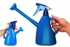 Two blue watering cans, one large and one small, with one being held by a hand. Produktbild-Vorschau