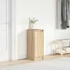 A narrow wooden cabinet with a door stands in a hallway next to a white door and a shoe rack with coats hanging above it. Anteprima dell’immagine prodotto
