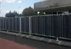 A fence with dark grey privacy screens is shown in front of a building. Produktbild-Vorschau