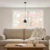 A pendant light hangs above a sofa in a living room setting. Produktbild-Vorschau