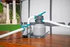 A sand filter pump system for a pool is set up on a wooden deck next to a pool. Produktbild-Vorschau