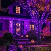 A house decorated with purple Halloween lights and pumpkins for a festive atmosphere. Produktbild-Vorschau