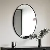 A modern interior scene featuring an oval mirror on a wall above a dark dresser. Produktbild-Vorschau