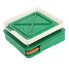 A capsule filling tool with a green base and a white and green lid. Voir les images du produit