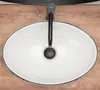 A top-down view of a white oval basin with a black faucet, set on a wooden surface. Náhled obrázku produktu