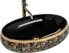 A black and gold oval washbasin with a gold faucet. Produktbild-Vorschau