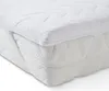 A close-up view of a white mattress topper on a mattress. Produktbild-Vorschau