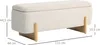 A cream-colored storage bench with wooden legs, shown from a side angle with dimensions indicated. Voir les images du produit