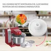 A red kitchen mixer with accessories and a close-up of chopped vegetables and a gear. Produktbild-Vorschau