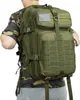 A person wearing a camouflage shirt and a grey t-shirt is shown from the back, wearing a green tactical backpack. Náhled obrázku produktu