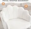A close-up view of a white, petal-shaped backrest of a chair. Produktbild-Vorschau