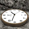 A wooden wall clock is placed on a textured, bark-like surface. Voir les images du produit