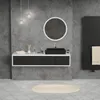 A modern bathroom vanity with a black sink, round mirror, and hanging lights. Podgląd zdjęcia produktu