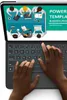 Hands typing on a backlit keyboard with a tablet screen showing a business presentation. Anteprima dell’immagine prodotto