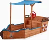 A wooden sandbox designed to look like a pirate ship, with a blue canopy and a red steering wheel. Produktbild-Vorschau