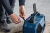 A person is plugging a cable into a Bosch work radio. Produktbild-Vorschau