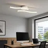 A modern office space with a desk, computer, and a ceiling light. Náhled obrázku produktu