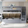 A gray bunk bed with a pull-out trundle bed and storage stairs in a child's bedroom. Náhled obrázku produktu