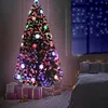 A decorated Christmas tree with gifts underneath, in a bedroom setting. Voir les images du produit