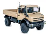 A toy model of a beige Mercedes-Benz Unimog U5023 truck, shown from a three-quarter front-left angle against a white background. The driver's side door is open, revealing the interior. Produktbild-Vorschau
