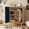 A shoe cabinet with its doors open, displaying shoes and a box on shelves, in a room setting with plants and a rug. Anteprima dell’immagine prodotto