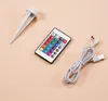 A collection of items for a solar garden light set, including a stake, a remote control, and a USB charging cable, laid out on a plain background. Produktbild-Vorschau