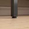 Close-up of the bottom of a black metal furniture leg resting on a light brown wooden floor. Anteprima dell’immagine prodotto