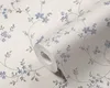 A roll of floral wallpaper with blue flowers and green leaves on a cream background. Produktbild-Vorschau