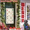 A decorated doorway with a Christmas advent calendar hanging on the door, surrounded by festive garlands and lights. A dog statue adorned with Christmas lights sits nearby. Produktbild-Vorschau